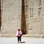 Dwarfed by the temple wall